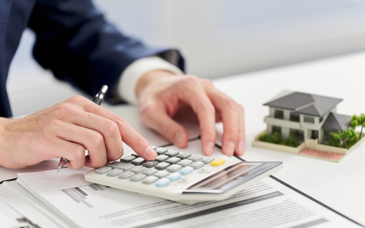 Businessman calculating money related to real estate %painting services% - Apex Coating Company, LLC. Why Cabinet Painting Cost Varies So Much Between Contractors (And What You're Really Paying For)